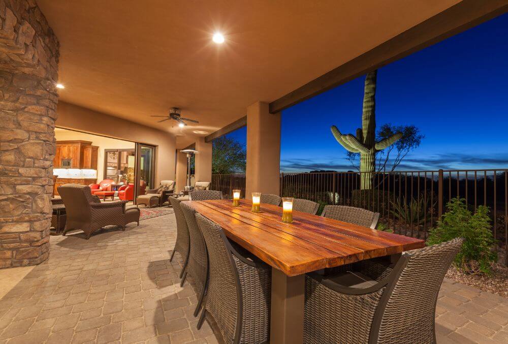 patio view at night with wood table and rattan chairs