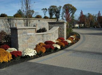 driveway apron with flowers on the lawn