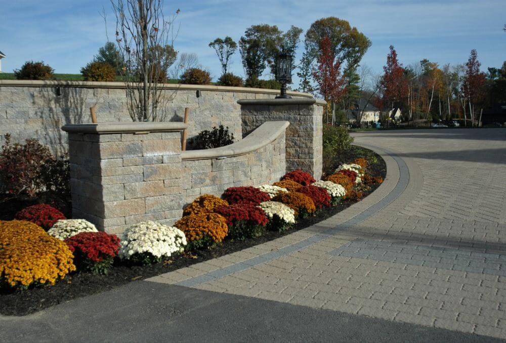 driveway apron with flowers on the lawn