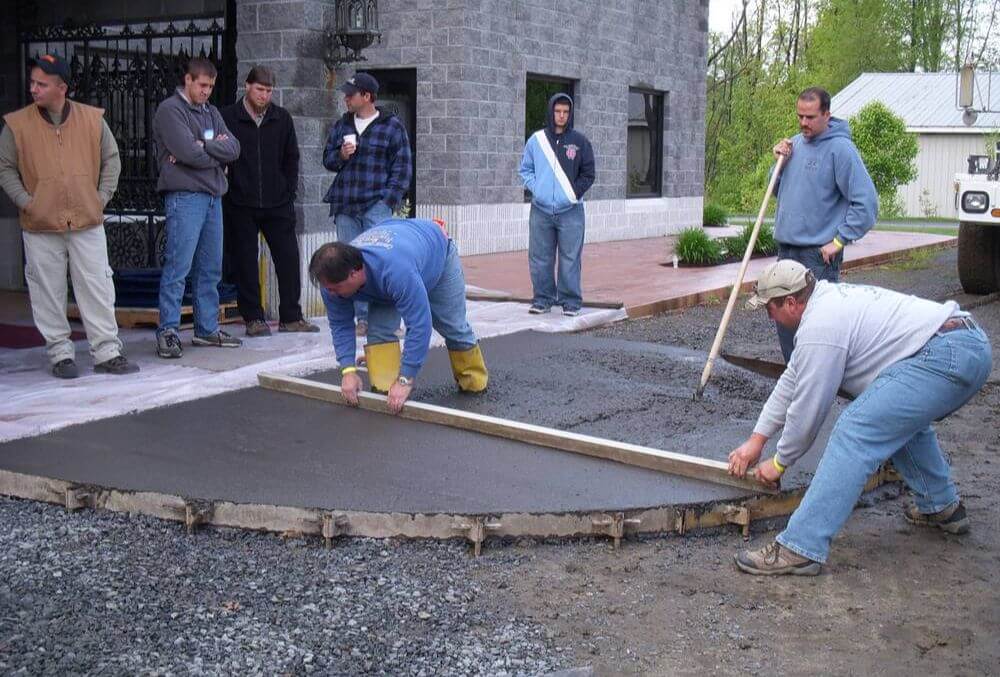 flooring contractors screeding the concrete driveway