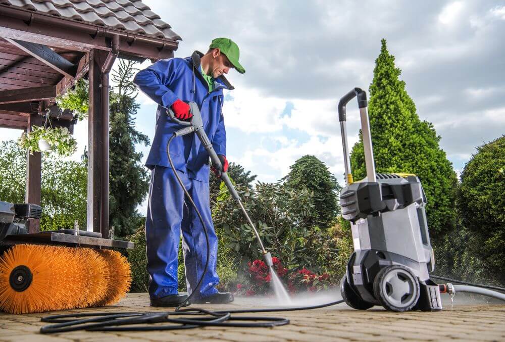 man power washing the concrete floor