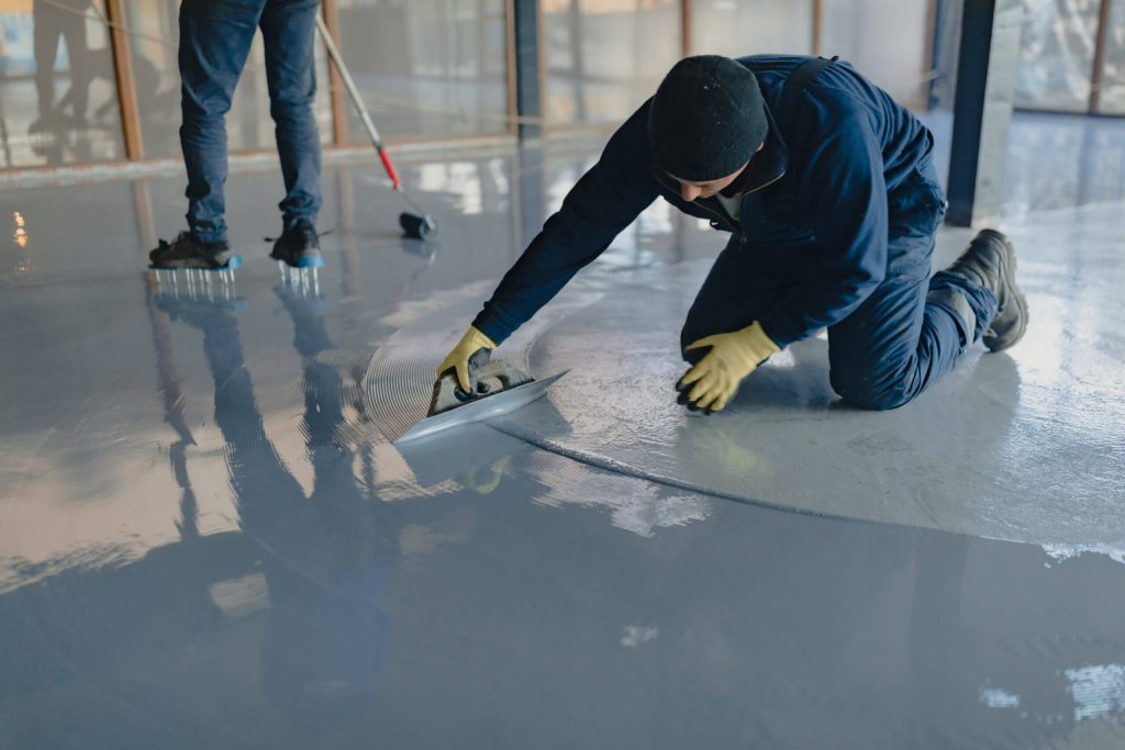 contractor applying epoxy on the floor