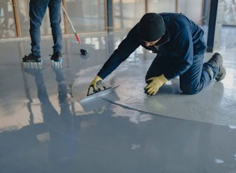 contractor applying epoxy on the floor