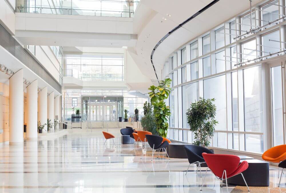 Hotel lobby with decorative concrete flooring featuring elegant patterns and a polished finish for a modern, durable, and upscale interior design.