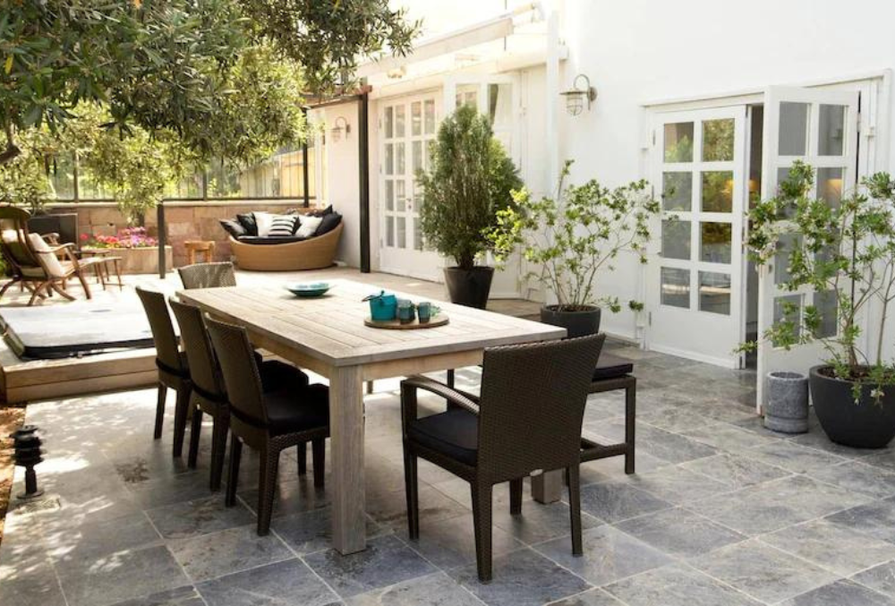 Outdoor dining area with plants candles