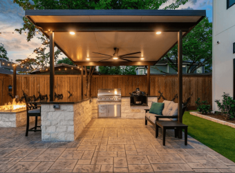 extended concrete patio with couch and a firepit