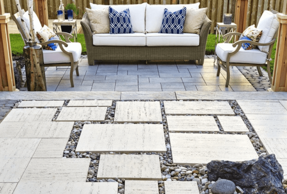 stamped concrete patio with a cozy couch and a throw pillow