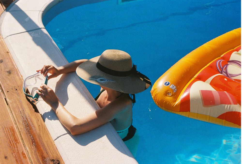 lady resting on a concrete pool deck