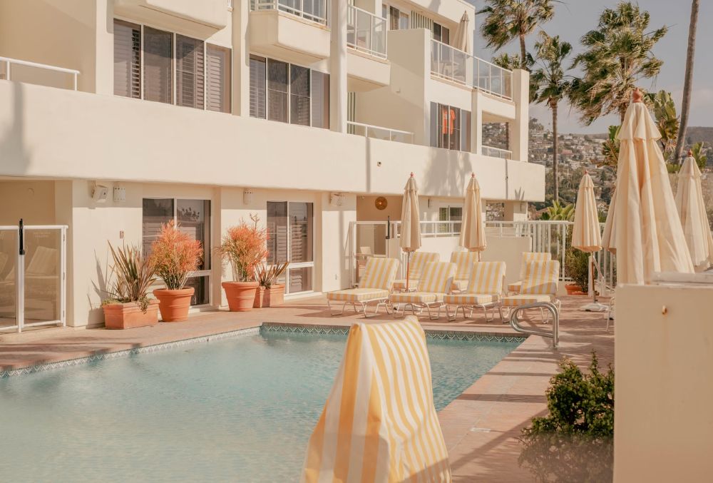 modern outdoor pool with tables and chairs