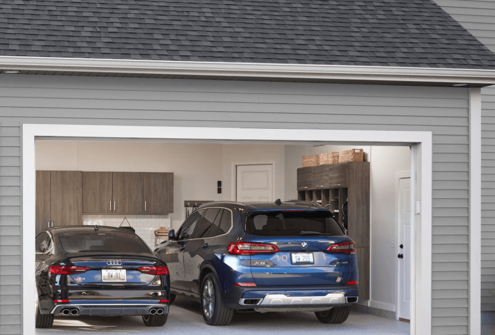 Two cars parked inside a clean, organized garage.