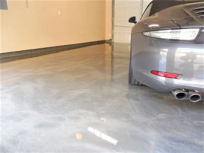 epoxy garage flooring with a silver ar parked